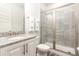 Clean bathroom with shower, toilet and granite vanity at 1136 Castle Pines Ct, Reunion, FL 34747