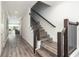 Modern staircase with dark wood accents and gray flooring at 1136 Castle Pines Ct, Reunion, FL 34747
