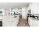 Modern kitchen with large island, stainless steel appliances, and granite countertops at 1136 Castle Pines Ct, Reunion, FL 34747