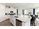 Modern kitchen with large island, stainless steel appliances, and granite countertops at 1136 Castle Pines Ct, Reunion, FL 34747