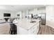 Modern kitchen with large island, stainless steel appliances, and granite countertops at 1136 Castle Pines Ct, Reunion, FL 34747