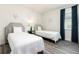 Bedroom with two twin beds, gray headboard, and blue curtains at 1136 Castle Pines Ct, Reunion, FL 34747
