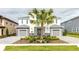 Two-story home with gray stone accents and landscaping at 1136 Castle Pines Ct, Reunion, FL 34747