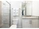 Clean bathroom with granite countertop, white cabinets, and a shower at 1136 Castle Pines Ct, Reunion, FL 34747