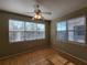 Bright bedroom with wood floors and two large windows at 3446 Soho St # 304, Orlando, FL 32835