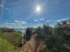 Lake view from condo; sunny day with blue skies at 3446 Soho St # 304, Orlando, FL 32835
