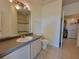 Bathroom includes a toilet, sink vanity, and access to laundry at 3446 Soho St # 304, Orlando, FL 32835