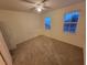 Spacious bedroom with neutral walls, ceiling fan and two windows at 3446 Soho St # 304, Orlando, FL 32835