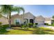 Tan house with lush landscaping and palm trees at 3846 Cabo Rojo Dr, Saint Cloud, FL 34772