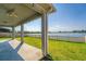 Covered patio overlooking a lake with a fenced yard at 3846 Cabo Rojo Dr, Saint Cloud, FL 34772