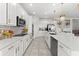 Modern kitchen with white cabinets and island at 3846 Cabo Rojo Dr, Saint Cloud, FL 34772