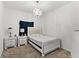 Bright bedroom with a queen-size bed, nightstands, and chandelier at 3846 Cabo Rojo Dr, Saint Cloud, FL 34772