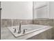 Modern bathroom with soaking tub and tile surround at 3846 Cabo Rojo Dr, Saint Cloud, FL 34772