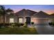 Two-story house with attached garage and landscaping at 3846 Cabo Rojo Dr, Saint Cloud, FL 34772