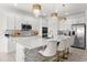 Modern kitchen with large island, white cabinets, and stainless steel appliances at 3846 Cabo Rojo Dr, Saint Cloud, FL 34772