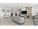 Bright living room featuring a large TV, comfortable seating, and tile floors at 3846 Cabo Rojo Dr, Saint Cloud, FL 34772