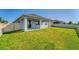 Spacious backyard with covered patio and grassy area at 3846 Cabo Rojo Dr, Saint Cloud, FL 34772