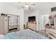 Bright bedroom with mirrored closet doors and TV at 3846 Cabo Rojo Dr, Saint Cloud, FL 34772