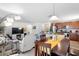Open dining area with wooden table, view of kitchen and living room at 2862 Mosshire Cir, St Cloud, FL 34772