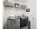 Laundry room with washer, dryer, and shelving at 2862 Mosshire Cir, St Cloud, FL 34772
