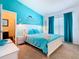 Bright bedroom with a white bed frame and teal bedding at 114 Castlemain Cir, Davenport, FL 33897