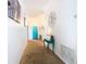 Bright hallway with teal accent table and a teal door at 114 Castlemain Cir, Davenport, FL 33897