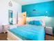 Serene bedroom with a white bed frame and teal bedding at 114 Castlemain Cir, Davenport, FL 33897