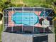 Aerial view of a refreshing pool and patio with solar panels at 114 Castlemain Cir, Davenport, FL 33897
