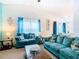 Living room with teal couches and wood coffee table at 114 Castlemain Cir, Davenport, FL 33897