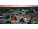 Aerial view of homes at dusk near a pond at 5204 Oakbourne Ave, Davenport, FL 33837