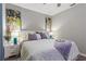 King-size bed in a serene bedroom with gray walls and artwork at 5204 Oakbourne Ave, Davenport, FL 33837