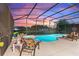 View of a pool and patio area with lounge chairs at sunset at 5204 Oakbourne Ave, Davenport, FL 33837