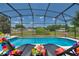 Inviting pool and spa with lounge chairs and covered patio at 5204 Oakbourne Ave, Davenport, FL 33837