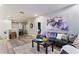 Open living area with L-shaped sofa, coffee table, and wood-look flooring at 5204 Oakbourne Ave, Davenport, FL 33837