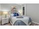 Bedroom with a queen bed, soft blue bedding, and white nightstands at 5204 Oakbourne Ave, Davenport, FL 33837