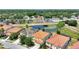Aerial view of houses with red tile roofs near a pond at 5204 Oakbourne Ave, Davenport, FL 33837