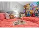 Two twin beds in a bright bedroom featuring a mural and decorative accents at 5204 Oakbourne Ave, Davenport, FL 33837