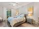 Bright main bedroom with a king-size bed and access to a private balcony at 5204 Oakbourne Ave, Davenport, FL 33837