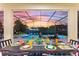 Table set for outdoor dining with a view of the pool and sunset at 5204 Oakbourne Ave, Davenport, FL 33837