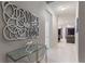 Entryway with glass table, metal wall art, and view to living room at 5204 Oakbourne Ave, Davenport, FL 33837