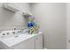 Convenient laundry room with washer, dryer, and shelving at 5204 Oakbourne Ave, Davenport, FL 33837