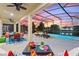 Evening view of pool and patio with outdoor dining and seating at 5204 Oakbourne Ave, Davenport, FL 33837