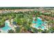 Aerial view of community with pools, palm trees and tennis courts at 5204 Oakbourne Ave, Davenport, FL 33837
