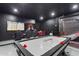 Entertain in this game room with air hockey, large TV, and gaming chairs at 5204 Oakbourne Ave, Davenport, FL 33837