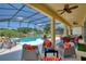 Spacious covered patio overlooking the pool and spa at 5204 Oakbourne Ave, Davenport, FL 33837