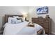 Bedroom with a wooden bed frame, light bedding, and a neutral color palette at 5204 Oakbourne Ave, Davenport, FL 33837