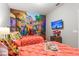 Two twin beds in a cheerful bedroom with a colorful mural and fun decor at 5204 Oakbourne Ave, Davenport, FL 33837
