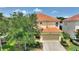 Two-story house with terracotta tile roof and well-maintained landscaping at 5204 Oakbourne Ave, Davenport, FL 33837