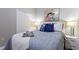 Cozy bedroom with a queen bed, blue bedding, and white nightstands at 5204 Oakbourne Ave, Davenport, FL 33837