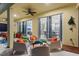 Covered patio with seating area and view into the home at 5204 Oakbourne Ave, Davenport, FL 33837